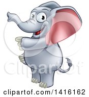 Clipart Of A Cartoon Happy Elephant Standing And Pointing Royalty Free Vector Illustration