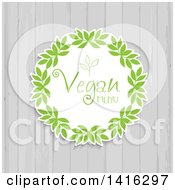 Clipart Of A Round Leaf Vegan Menu Design Over White Wood Royalty Free Vector Illustration by KJ Pargeter