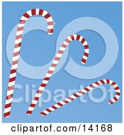 Three Red And White Striped Peppermint Candy Canes On A Blue Background Christmas Clipart Illustration