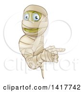 Clipart Of A Cartoon Happy Halloween Mummy Pointing Around A Sign Royalty Free Vector Illustration