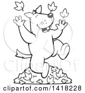 Cartoon Clipart Of A Black And White Lineart Happy Wolf Playing In Autumn Leaves Royalty Free Vector Illustration