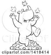 Cartoon Clipart Of A Black And White Lineart Happy Rhino Playing In Autumn Leaves Royalty Free Vector Illustration
