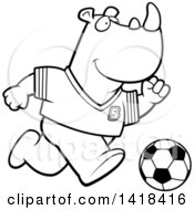 Cartoon Clipart Of A Black And White Lineart Sporty Rhino Playing Soccer Royalty Free Vector Illustration