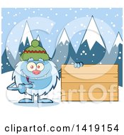 Cartoon Yeti Abominable Snowman Wearing A Winter Hat And Pointing To A Blank Wood Sign