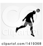 Poster, Art Print Of Black Silhouetted Male Soccer Player Head Passing A Ball Over Gray