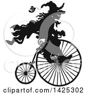 Poster, Art Print Of Black Silhouetted Halloween Witch Riding A Penny Farthing Bicycle
