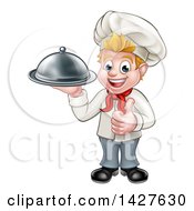 Poster, Art Print Of Happy Young Blond White Male Chef Holding A Cloche Platter And Giving A Thumb Up