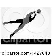 Poster, Art Print Of Black Silhouetted Goal Keeper Soccer Player Blocking The Ball Over Gray