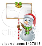 Poster, Art Print Of Happy Christmas Snowman Wearing A Santa Hat And Pointing To A Blank Sign