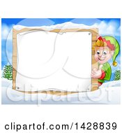 Poster, Art Print Of Happy Caucasian Male Christmas Elf Giving A Thumb Up Around A Blank Sign In A Winter Landscape