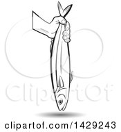 Clipart Of A Black And White Hand Holding A Fish Royalty Free Vector Illustration