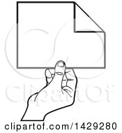 Poster, Art Print Of Black And White Hand Holding A Piece Of Paper