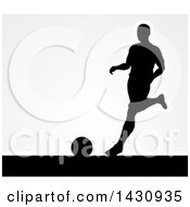 Poster, Art Print Of Black Silhouetted Male Soccer Player Kicking Over Gray