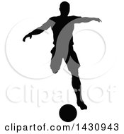 Clipart Of A Black Silhouetted Male Soccer Player Kicking Royalty Free Vector Illustration