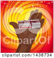 Poster, Art Print Of Hand Holding Out A Small Christmas Gift Box Over A Yellow And Red Swirl With Sparkles And Stars
