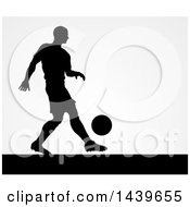 Clipart Of A Black Silhouetted Male Soccer Player Kicking Over Gray Royalty Free Vector Illustration