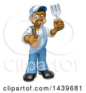 Clipart Of A Cartoon Full Length Happy Black Male Gardener In Blue Holding A Garden Fork And Giving A Thumb Up Royalty Free Vector Illustration