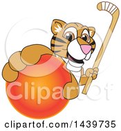 Tiger Cub School Mascot Character Grabbing A Hockey Ball And Holding A Stick