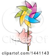 Childs Hand Holding A Colorful Spinning Pinwheel