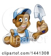 Poster, Art Print Of Cartoon Happy Black Male Gardener In Blue Holding A Garden Trowel And Giving A Thumb Up