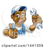 Clipart Of A Cartoon Happy Black Male Mechanic Holding Up A Wrench And Giving A Thumb Up Royalty Free Vector Illustration
