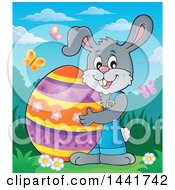 Poster, Art Print Of Happy Gray Easter Bunny Rabbit Holding A Giant Egg In A Spring Landscape