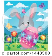 Clipart Of A Gray Easter Bunny Rabbit Holding A Decorated Egg Royalty Free Vector Illustration