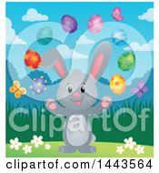 Clipart Of A Gray Easter Bunny Rabbit Juggling Decorated Eggs Royalty Free Vector Illustration