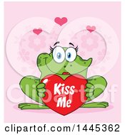 Poster, Art Print Of Cartoon Female Frog Holding A Red Valentine Kiss Me Love Heart Over Pink