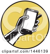 Poster, Art Print Of Retro Woodcut Hand Holding A Smart Phone In A Yellow And Black Circle