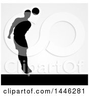 Clipart Of A Black Silhouetted Male Soccer Player Heading A Ball With Shading Over Gray Royalty Free Vector Illustration