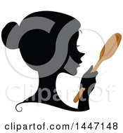 Clipart Of A Black Silhouetted Womans Profiled Face With A Wooden Spoon Royalty Free Vector Illustration