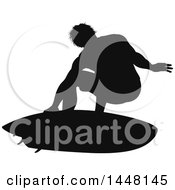 Clipart Of A Black Silhouetted Man Surfing Royalty Free Vector Illustration by AtStockIllustration