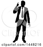 Clipart Of A Black And White Silhouetted Business Man Pointing Upwards Royalty Free Vector Illustration