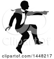 Clipart Of A Black And White Silhouetted Business Man Jumping And Pointing Royalty Free Vector Illustration