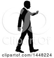 Black And White Silhouetted Business Man Walking And Checking His Watch