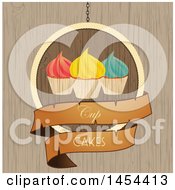 Clipart Graphic Of A Hanging Cupcake Sign Over Wood Texture Royalty Free Vector Illustration
