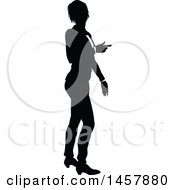 Clipart Of A Black And White Silhouetted Business Woman Pointing Royalty Free Vector Illustration