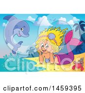Clipart Of A Happy Mermaid Resting Her Head In Her Hands On A Beach With A Dolphin Jumping In The Background Royalty Free Vector Illustration