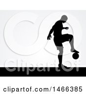 Poster, Art Print Of Black Silhouetted Male Soccer Player Kicking Over Gray