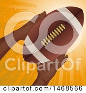 Poster, Art Print Of Pair Of Hands Holding A Football Over Orange Rays