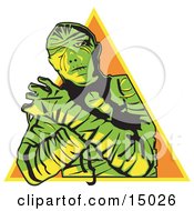 Mummy Wrapped Up With His Arms Crossed In Front Of Him And Cast In Green And Yellow Lighting Over An Orange Triangle