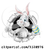 Poster, Art Print Of White Easter Bunny Rabbit Giving A Thumb Up And Holding An Egg While Emerging From A Hole
