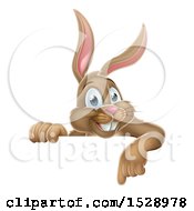 Clipart Of A Happy Brown Easter Bunny Rabbit Pointing Down Over A Sign Royalty Free Vector Illustration
