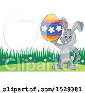 Clipart Of A Gray Bunny Rabbit Holding An Easter Egg Royalty Free Vector Illustration