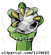 Clipart Of A Green Monster Claw Holding A Soccer Ball Royalty Free Vector Illustration by AtStockIllustration
