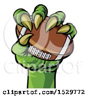Clipart Of A Green Monster Claw Holding A Football Royalty Free Vector Illustration