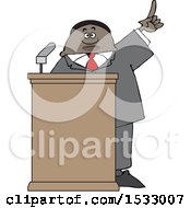 Black Male Politician Holding Up A Finger At A Podium