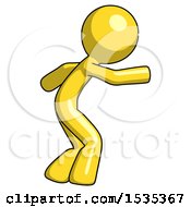Yellow Design Mascot Man Sneaking While Reaching For Something