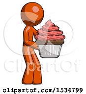 Orange Design Mascot Man Holding Large Cupcake Ready To Eat Or Serve